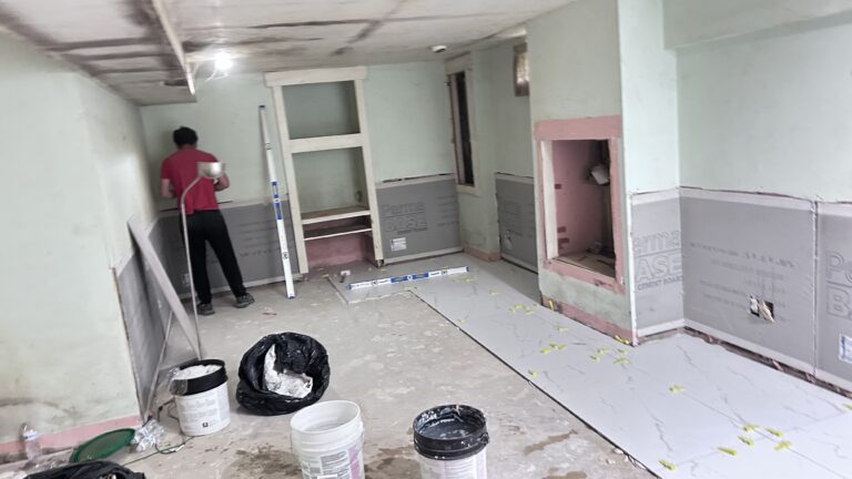 New Jersey basement renovation, replacing drywall with cement‑board and starting new tile flooring installation